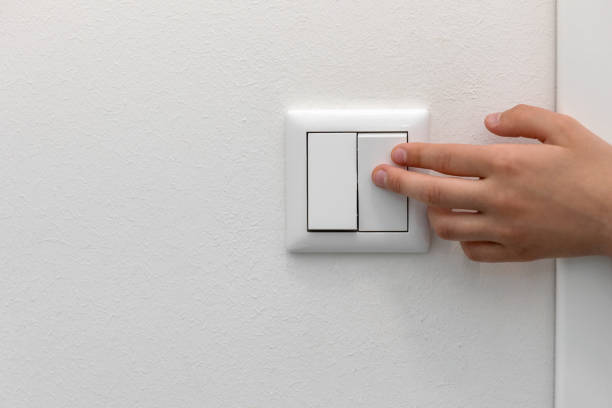Switching Off the Light Switching Off the Light, Turning Off Light Switch. Saving concept. Copy space. light switch stock pictures, royalty-free photos & images