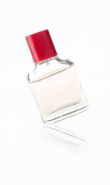 istock Small parfume bottle with red cap on, isolated on white background. 1410883898