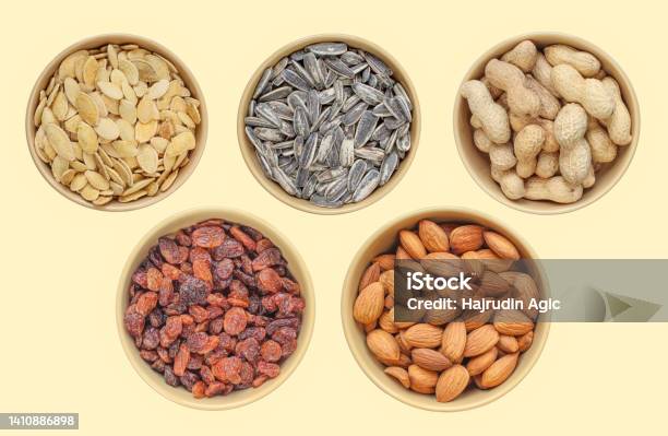 Five Types Of Snacks In Brown Bowl Sunflower Seeds Pumpkin Seeds Peanuts Raisins Almonds Above Shot Different Samples Stock Photo - Download Image Now