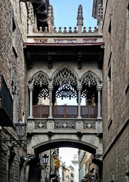 Barcelona, Spain - May 2018: Barri Gotic Quarter Carrer del Bisbe Bridge between stone walls of medieval buildings in in old town. Famous touristic landmark and travel destination.