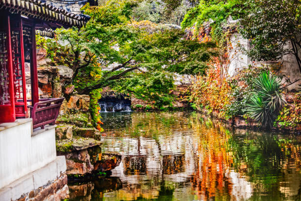 Garden Humble Administrator Ancient Red Houses Reflection Suzhou China Garden of Humble Administrator Zhouzheng Yuan Water Reflection Ancient Chinese House Suzhou Jiangsu China  Built in the 1500s UNESCO World Heritage Site suzhou stock pictures, royalty-free photos & images
