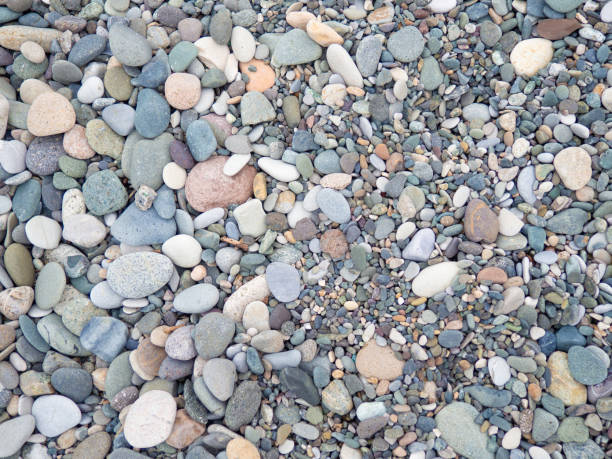 istock Large beach pebble. Background of small stones. Gray background from stones. Pattern. 1410894417