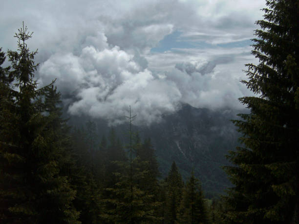 Mountain range under clouds. High angle view of winding road \