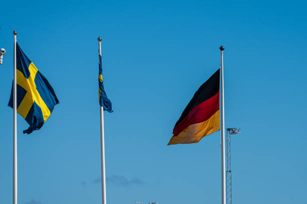 istock Swedish and german flag on flag poles.. 1410895644