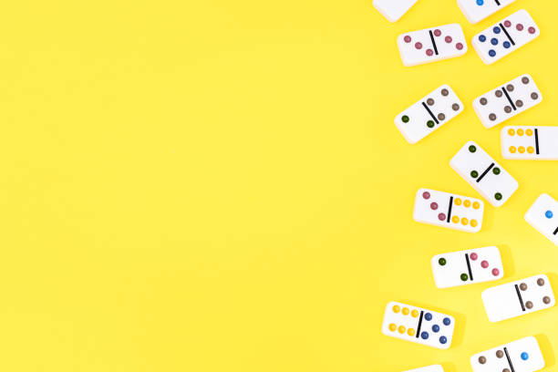 istock White dominoes on yellow background, top view. Board game. Place for text 1410896362