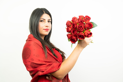 Close up of young beautiful teenage girl holding red roses ready for Valentine's day horizontal shot