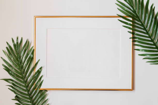 istock Mock up poster. Minimal template with empty picture frame mock up. White background with plants 1410897009