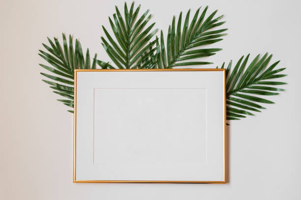 istock Mock up poster. Minimal template with empty picture frame mock up. White background with plants 1410897056