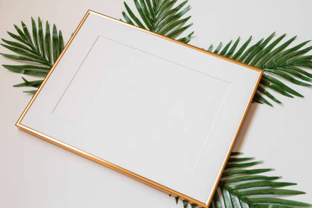 istock Mock up poster. Minimal template with empty picture frame mock up. White background with plants 1410897060