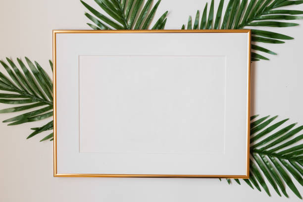 istock Mock up poster. Minimal template with empty picture frame mock up. White background with plants 1410897075