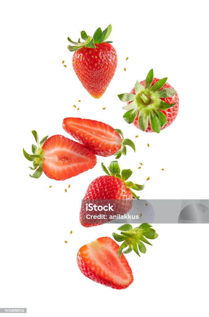 Fresh Strawberries in Air Whole and sliced strawberries in the air isolated on white background Strawberry Stock Photo