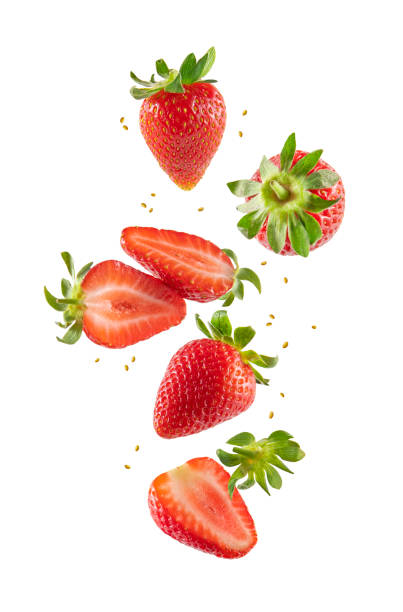 Fresh Strawberries in Air Whole and sliced strawberries in the air isolated on white background strawberry stock pictures, royalty-free photos & images