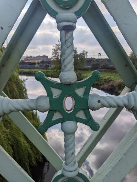 Daytime photo taken through the perspective of the bridge over the canal in Leeds