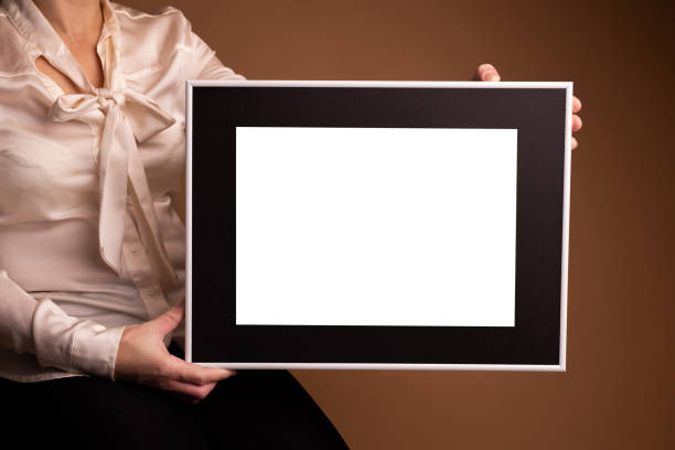 istock Mock up poster. Minimal template with empty picture frame mock up. Girl holding frame 1410899166