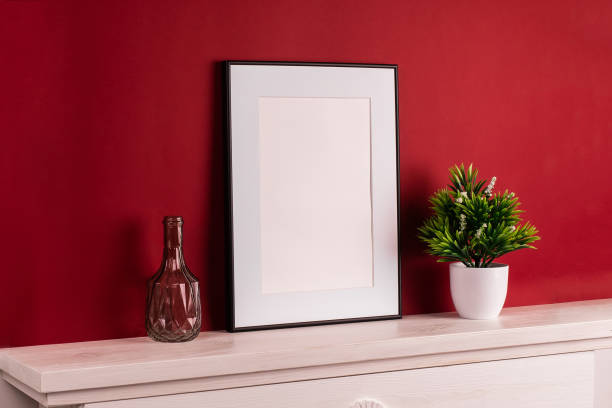 istock Mock up poster. Minimal template with empty picture frame mock up. Red background 1410899946