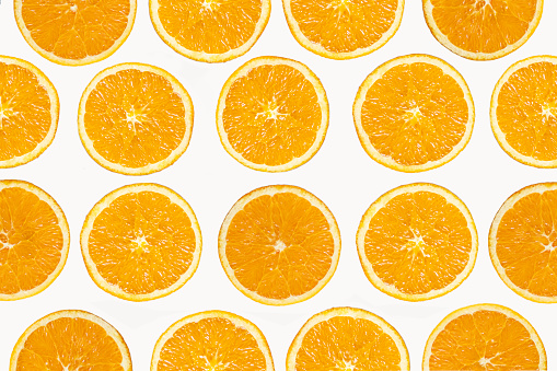 background photo of orange juice with oranges and juicer. Oranges are sliced. orange juice is squeezed. Shot with a full frame camera.