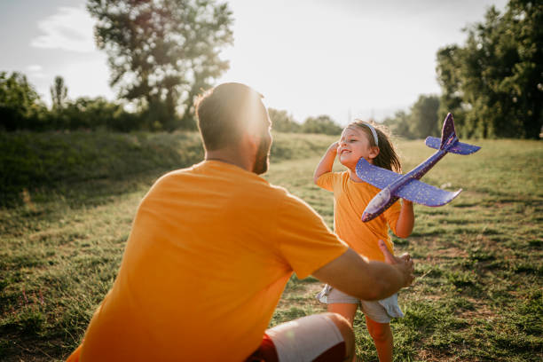 istock Father and daughter with model airplane 1410902012
