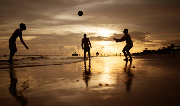 istock Playing volleyball on the beach at sunset 1410904740