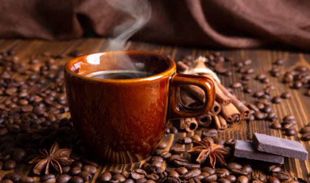 istock ceramic brown cup with black coffee and grains on wooden background still life 1410905509