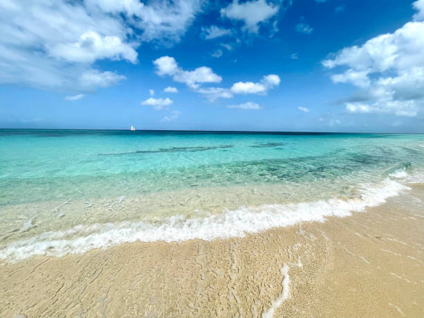 istock Distant Sailboat Near a Beautiful Beach 1410905754
