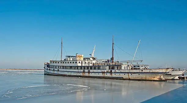 Photo of Rusty steamer in a frozen lake