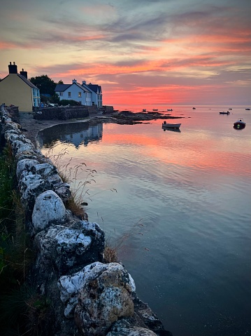 Sunset over houses and fishing harbor in Pembrokeshire, Wales