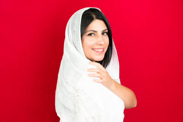 istock middle eastern woman with white scarf, red background 1410910890