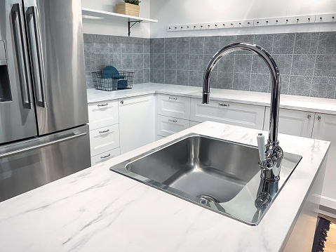 Sink in domestic kitchen with kitchen island