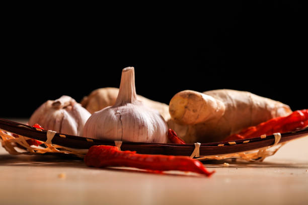 Various spices used to season west indian dishes - garlic,scallions,spring onion,onion,red onion,peppers