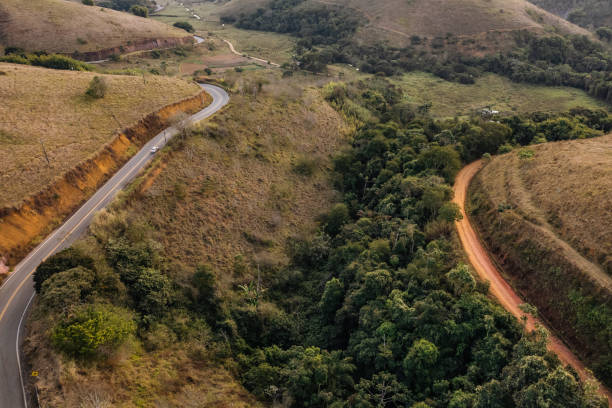 istock Dirt road next to asphalt road 1410914121