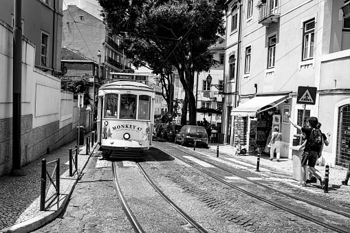 Lisbon, Portugal- July 4,2022; Famous yellow vintage tram on the street in Lisbon, Portugal. Famous travel destination