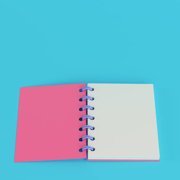istock Pink notepad on bright blue background in pastel colors 1410915898