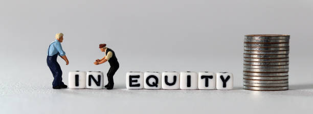 istock White cube with the word 'EQUITY'. Two miniature men and white cube with an 'IN'. 1410916650