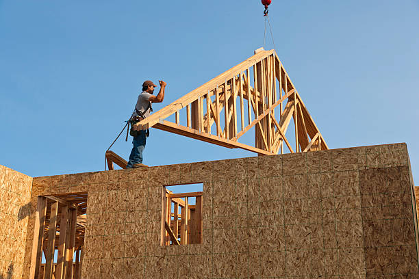istock Roof Trusses Being Hoisted Onto Unfinished Home Frame 141091772