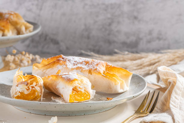 istock Typical portuguese sweets Pasteis de Vouzela served on countertop. Filo pastry with egg cream filling 1410918578