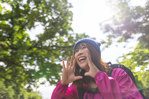 Japanese woman visiting Mt. Takao for hiking, and walking up to the peak.