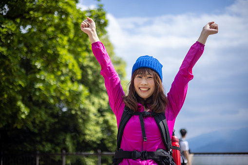 Japanese woman visiting Mt. Takao for hiking, and walking up to the peak.