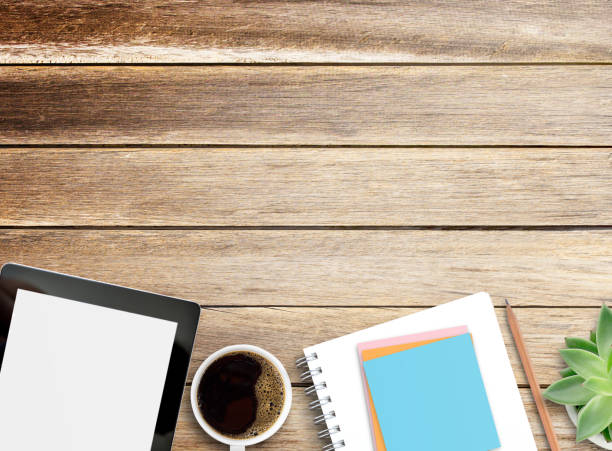 istock Blank notebook,pencil and tablet on wood table background. 1410922874