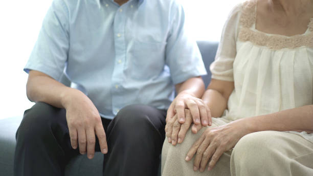 istock Man talking to elder Asian woman. 1410923485