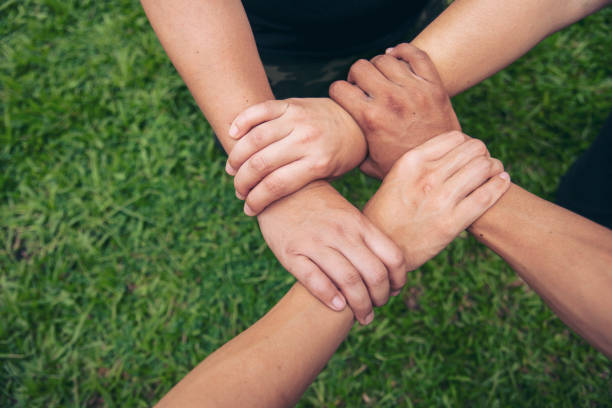 istock Close up hands Diverse multiethnic Partners team together. Teamwork group of multi racial people meeting join hands. Diversity people hands join empower partnership teams connect volunteer community 1410923563