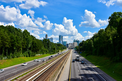 North and southbound lanes of the Georgia 400 highway plus tracks of the MARTA Mass Transit trains