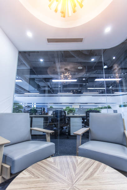 istock Conversation space in modern office interior with glass screen, sofa and round wooden table 1410929085