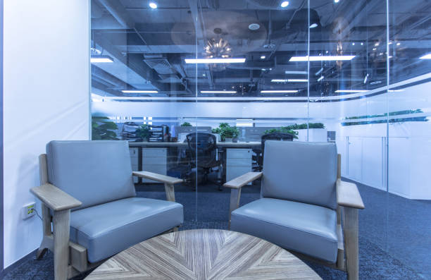 istock Conversation space in modern office interior with glass screen, sofa and round wooden table 1410929088