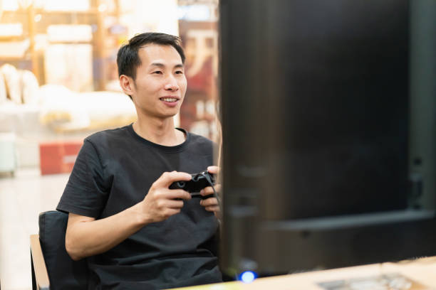 istock Close-up of man using gamepad to play game 1410930054