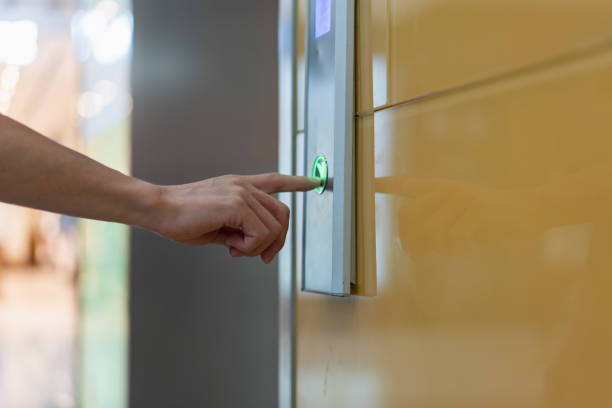 istock Close-up of a hand pressing the elevator down button 1410930136