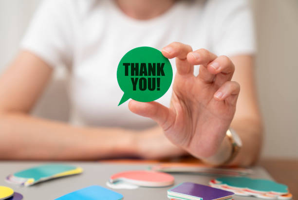 istock Woman holding speech bubble. Thank you message on speech bubble. 1410931749