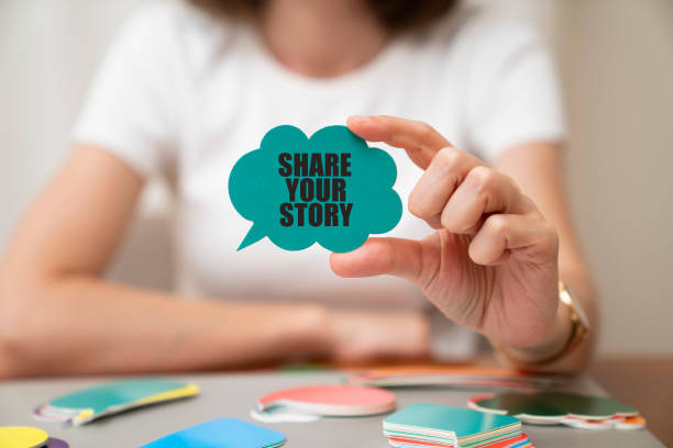 Woman holding speech bubble. Share  your story message on speech bubble. Woman wearing white t-shirt holding paper card bubble. Share  your story message on speech bubble. storytelling stock pictures, royalty-free photos & images
