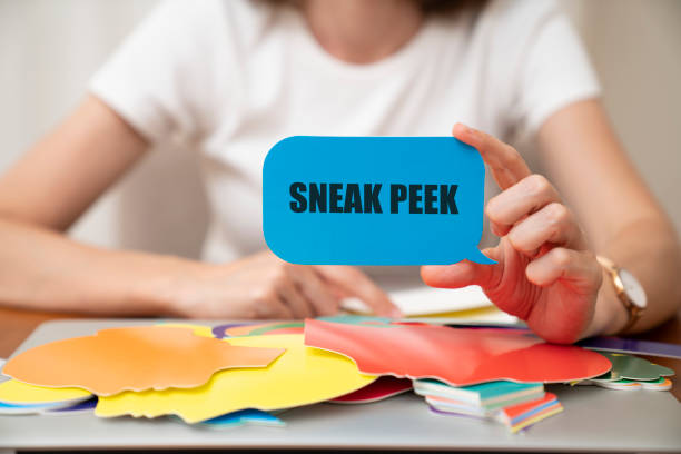 istock Woman holding speech bubble. Sneak peek message on speech bubble. 1410938618