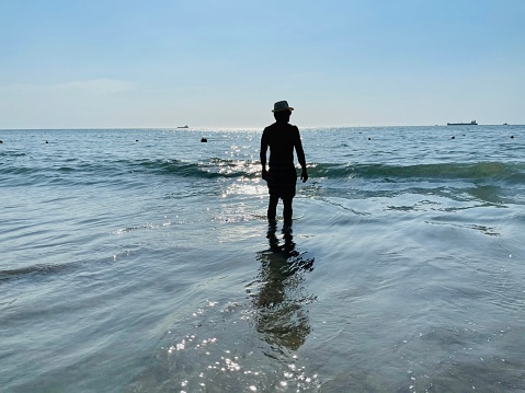 Young man going to swim on the Santa Marta beach