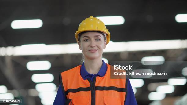 Professional Female Manager Or Worker Wearing Hard Hat And Safety Vest Have Confident And Leadership Walking To Work In The Retail Warehouse Smiling And Looking At The Camera Employee Working On Product Distribution Logistics Center Stock Photo - Download Image Now